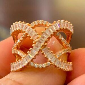 14k Rose gold with swirls of diamonds in baguette and round . size 7